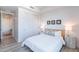 Bright bedroom with a queen bed, double doors, and wood-look floors at 3131 N Central Ave # 5022, Phoenix, AZ 85012
