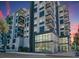 Modern building exterior at dusk, featuring glass and balconies at 3131 N Central Ave # 5022, Phoenix, AZ 85012