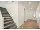 Gray carpeted staircase and tile entryway flooring at 32922 N Pebble Creek Dr, San Tan Valley, AZ 85143