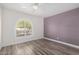 Spacious bedroom featuring hardwood floors and a large window with shutters at 3315 E Hampton Ave, Mesa, AZ 85204