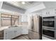Modern kitchen with stainless steel appliances and white cabinets at 3315 E Hampton Ave, Mesa, AZ 85204