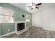 Living room with fireplace and soothing green accent wall at 3315 E Hampton Ave, Mesa, AZ 85204