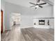 Spacious living room with wood-look floors and a white brick fireplace at 3315 E Hampton Ave, Mesa, AZ 85204