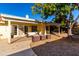 Relaxing covered patio with wicker furniture and landscaping at 3315 E Hampton Ave, Mesa, AZ 85204