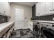 Bright laundry room with modern washer and dryer, custom cabinetry, and tile flooring at 3476 E Bartlett Pl, Chandler, AZ 85249