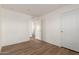 Simple bedroom with wood-look floors and access to hallway at 35041 W Euclid Ave, Tonopah, AZ 85354