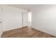 Spacious bedroom with wood-look floors and an interior door at 35041 W Euclid Ave, Tonopah, AZ 85354