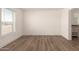 Spacious bedroom with wood-look floors and adjacent bathroom at 35041 W Euclid Ave, Tonopah, AZ 85354