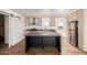Modern kitchen with island, stainless steel appliances, and light cabinets at 35041 W Euclid Ave, Tonopah, AZ 85354