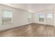 Spacious living room featuring wood-look floors and large windows at 35041 W Euclid Ave, Tonopah, AZ 85354