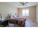 Spacious bedroom with ceiling fan and wood flooring at 41331 W Lucera Ln, Maricopa, AZ 85138