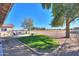 Landscaped backyard with grassy area and fire pit at 50209 W Gail Ln, Maricopa, AZ 85139