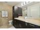 Modern bathroom with dark vanity and large mirror at 7117 E Rancho Vista Dr # 3004, Scottsdale, AZ 85251