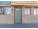 Inviting exterior of a home featuring a green door and brick facade at 8961 W Century Dr, Arizona City, AZ 85123