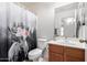 Charming bathroom with a floral shower curtain at 931 W Cedar Tree Dr, San Tan Valley, AZ 85143