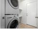 Stackable LG washer and dryer in a well-lit laundry room with extra shelving at 931 W Cedar Tree Dr, San Tan Valley, AZ 85143