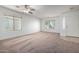 Bright living room with neutral carpeting and ceiling fan at 931 W Cedar Tree Dr, San Tan Valley, AZ 85143