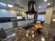 Modern kitchen with white cabinets, granite countertops, and stainless steel appliances at 11411 N 91St Ave # 29, Peoria, AZ 85345