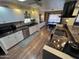 Open concept kitchen boasting white cabinets, granite counters, and stainless steel appliances at 11411 N 91St Ave # 29, Peoria, AZ 85345