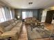 Living room features two brown sofas and a glass coffee table at 11411 N 91St Ave # 29, Peoria, AZ 85345