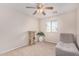 Bedroom with a gray chair, cat tree, and ceiling fan at 12363 W Turney Ave, Avondale, AZ 85392