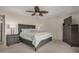 Comfortable bedroom with ceiling fan, dresser, and neutral color palette at 12402 W Cougar Dr, Sun City West, AZ 85375