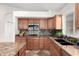 Kitchen with granite countertops, wood cabinets, and a double sink at 1409 W Maria Ln, Tempe, AZ 85284