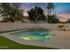 Spacious pool area with artificial turf and a rock waterfall at 1418 S Almar Cir, Mesa, AZ 85204