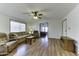 Bright living room with vaulted ceiling, laminate flooring, and comfy furniture at 17200 W Bell Rd # 1745, Surprise, AZ 85374