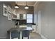 Wet bar with dark countertop and stylish shelving at 19198 N 95Th Pl, Scottsdale, AZ 85255