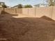 Large, unlandscaped backyard with block wall fencing at 21018 E Calle Luna Ct, Queen Creek, AZ 85142
