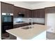 Kitchen island with sink, stainless steel appliances, and light countertops at 21018 E Calle Luna Ct, Queen Creek, AZ 85142