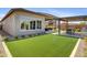 Artificial turf backyard with covered patio and outdoor kitchen at 26032 S 229Th Pl, Queen Creek, AZ 85142