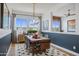 Elegant dining room with a rustic wood table and modern chandelier at 26032 S 229Th Pl, Queen Creek, AZ 85142