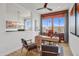 Bright home office features wood desk, two chairs, and large windows at 26032 S 229Th Pl, Queen Creek, AZ 85142