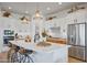 Open kitchen with white cabinets, quartz counters, and an island with seating at 26032 S 229Th Pl, Queen Creek, AZ 85142