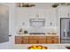 Sleek kitchen with wood cabinets, a gas range and quartz countertops at 26032 S 229Th Pl, Queen Creek, AZ 85142