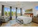 Main bedroom with large windows, comfortable bed and sitting area at 26032 S 229Th Pl, Queen Creek, AZ 85142