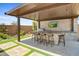 Modern outdoor kitchen with built-in grill, bar seating, and TV at 26032 S 229Th Pl, Queen Creek, AZ 85142