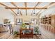 Spacious living room with wood beam ceiling, fireplace, built-in shelves, and ample seating at 3331 E Fairbrook St, Mesa, AZ 85213