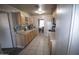 View of a kitchen with wood cabinets and tiled floors at 3418 W Roma Ave, Phoenix, AZ 85017