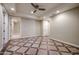 Well-lit bedroom with tile flooring and access to hallway at 3702 E Brown Rd, Mesa, AZ 85205