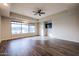 Bedroom with large window, wood-look floors, and a ceiling fan at 3702 E Brown Rd, Mesa, AZ 85205