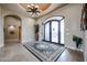 Elegant entryway with double doors, tiled floor and chandelier at 3702 E Brown Rd, Mesa, AZ 85205