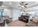 Spacious living room with leather couches, ceiling fan and view into kitchen at 379 N Marcos Ct, Casa Grande, AZ 85194