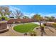 Backyard with a putting green, pool, and fire pit at 4633 N 127Th Dr, Litchfield Park, AZ 85340
