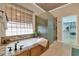 Relaxing bathroom with a soaking tub, walk-in shower, and granite vanity at 4633 N 127Th Dr, Litchfield Park, AZ 85340