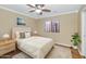 Bedroom with wood floors, ceiling fan, and large window at 4633 N 127Th Dr, Litchfield Park, AZ 85340