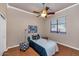 Cozy bedroom with hardwood floors and ceiling fan at 4633 N 127Th Dr, Litchfield Park, AZ 85340