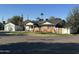 Single-story home with a two-car garage, brick and white exterior, and a landscaped front yard at 5217 N 18Th Pl, Phoenix, AZ 85016